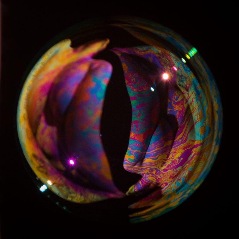 Model inside a bubble with psychedelic colors